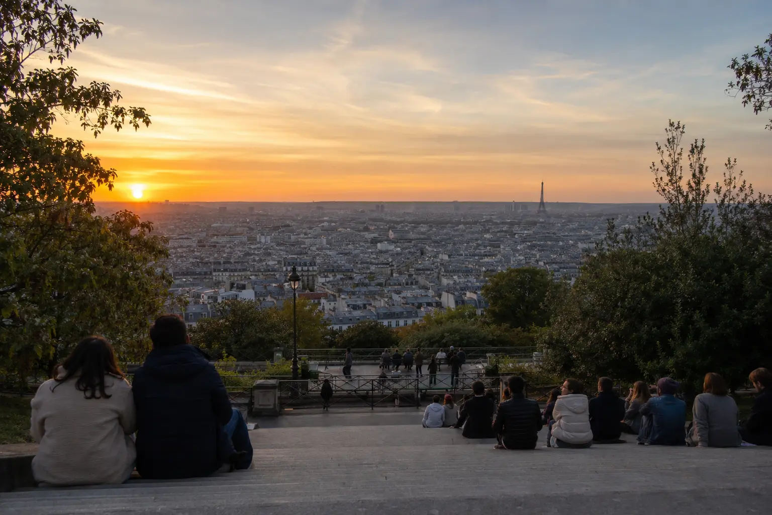 Visitors watching sunset over Paris from Parc de Belleville