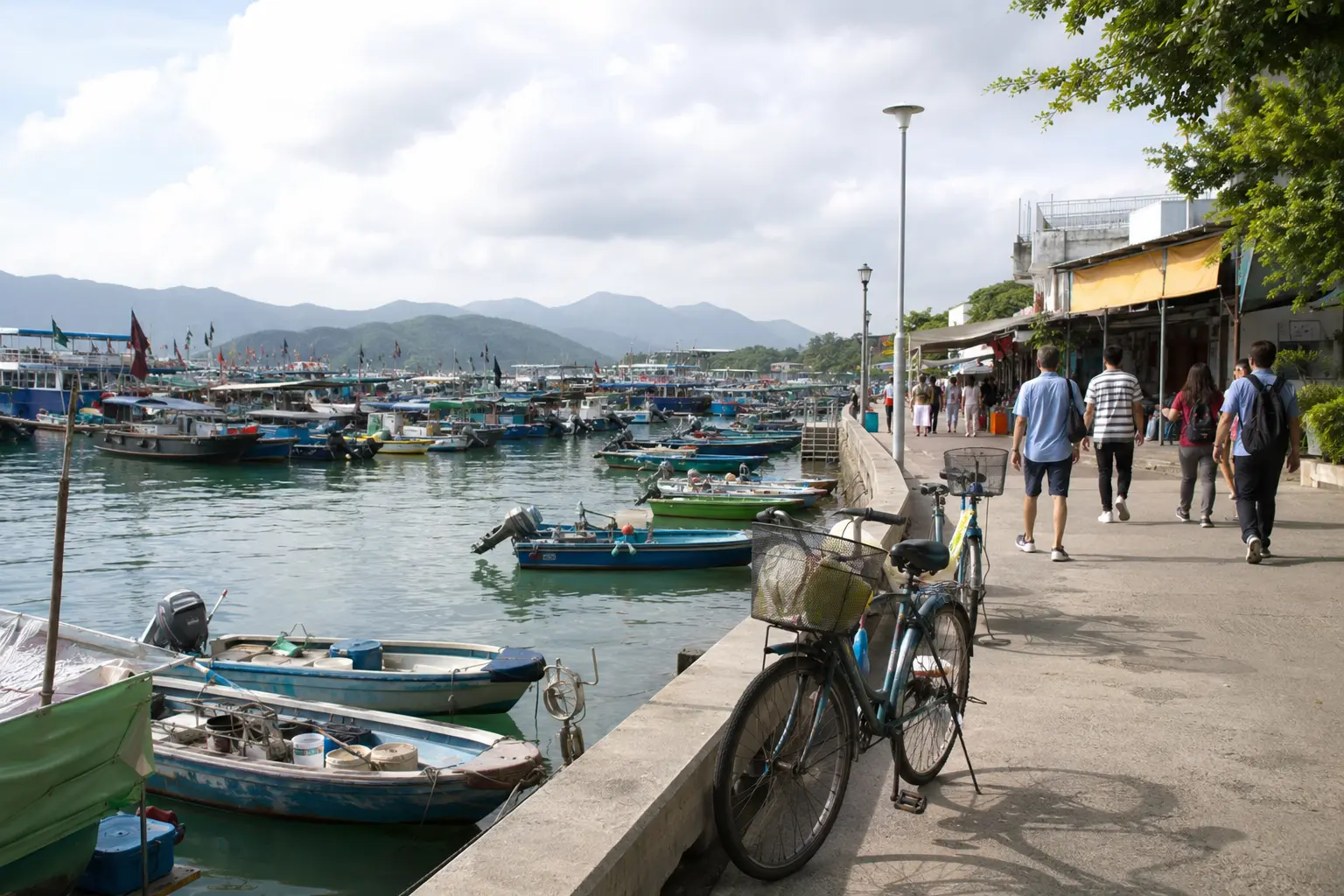 Bicycles and pedestrians beside fishing boats on the Cheung Chau waterfront