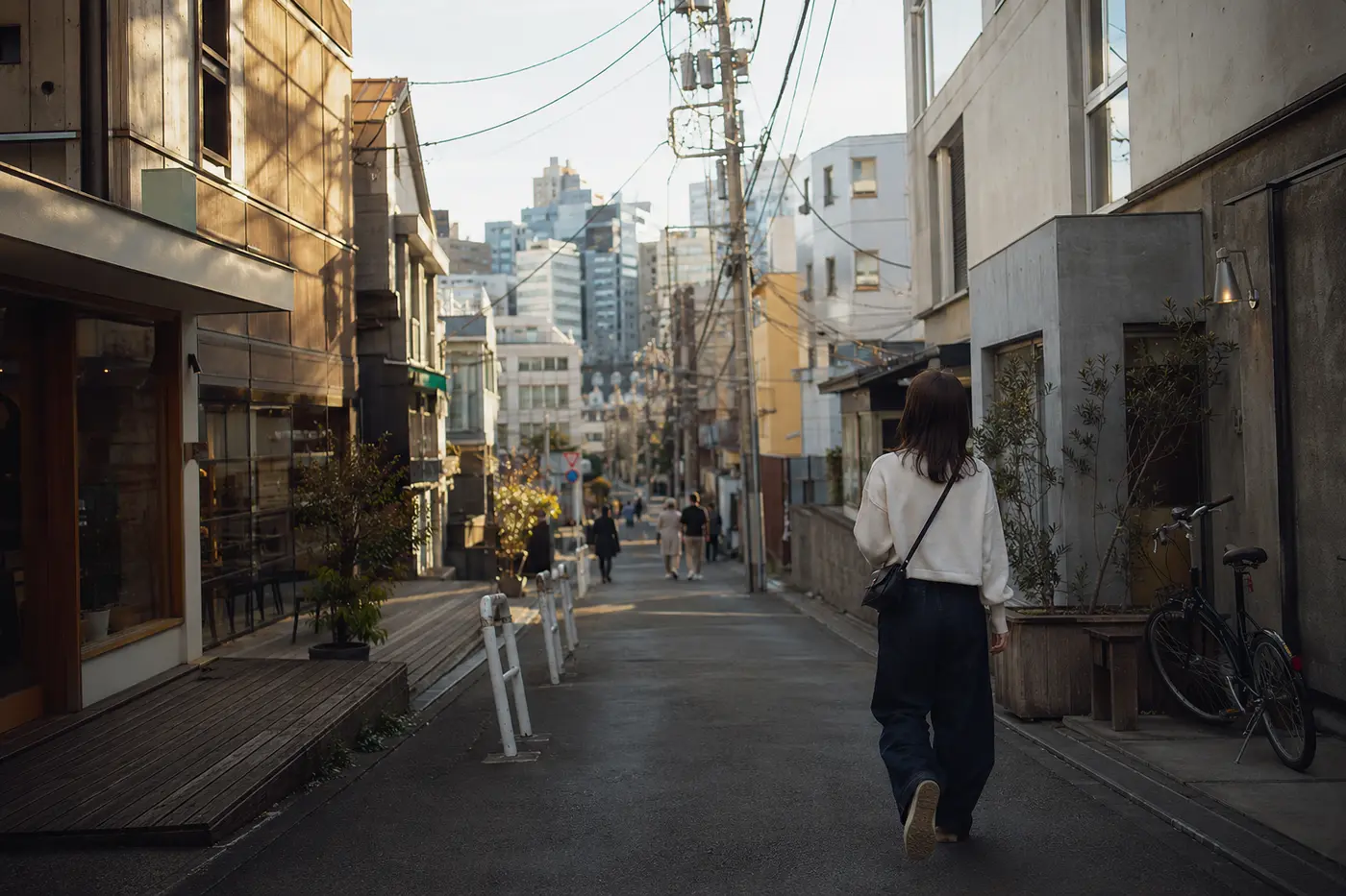 Traveler walking a quiet backstreet between Harajuku and Shibuya