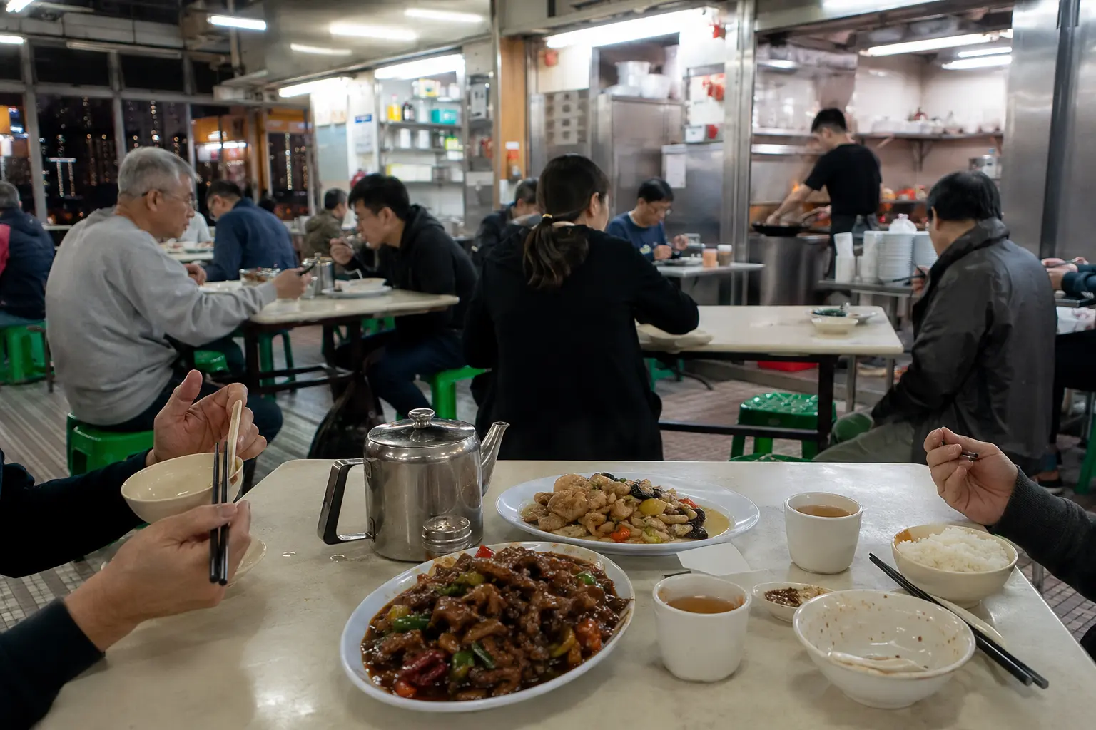 Diners sharing wok-fried dishes in a Hong Kong cooked food centre