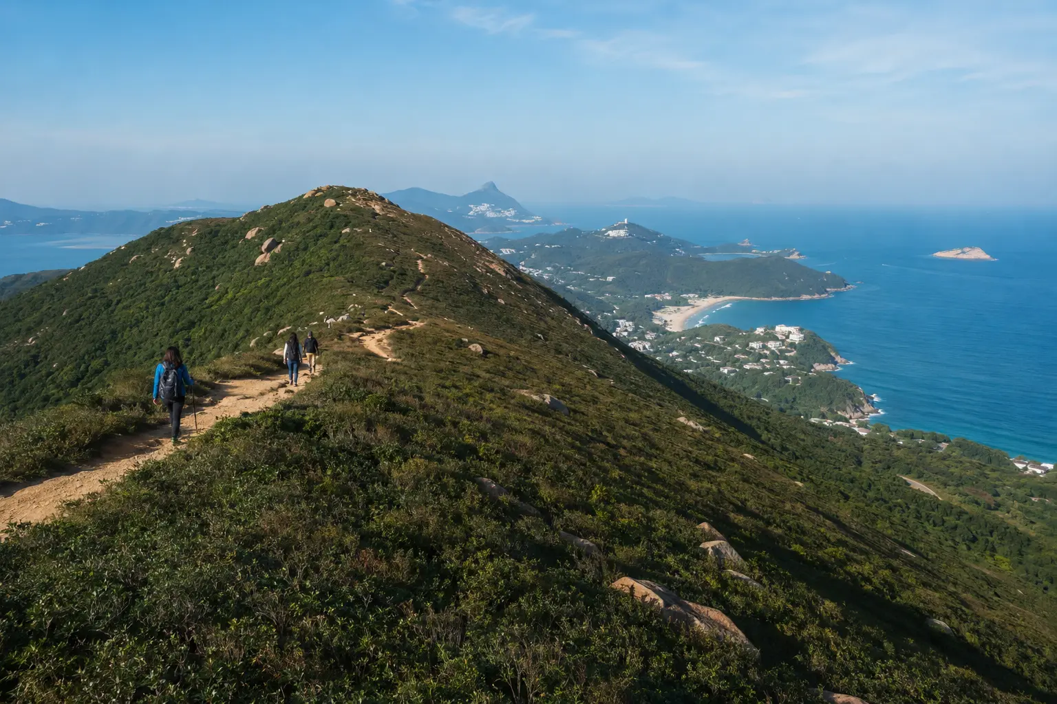 Hikers following the Dragon's Back ridge on a clear winter day in Hong Kong
