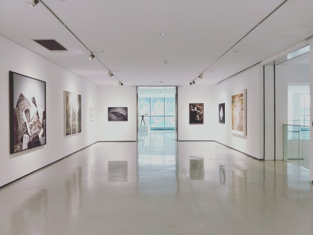 Visitors viewing paintings in a contemporary art gallery