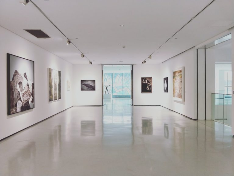 Visitors viewing paintings in a contemporary art gallery