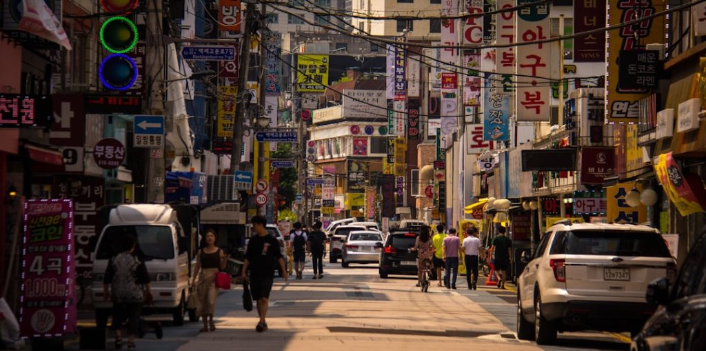 Young people walking through a lively Seoul street