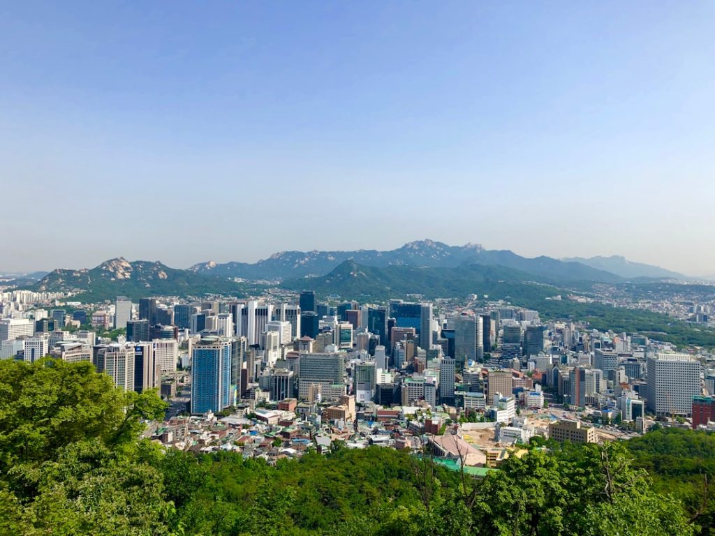Wide view of Seoul with mountains beyond the city