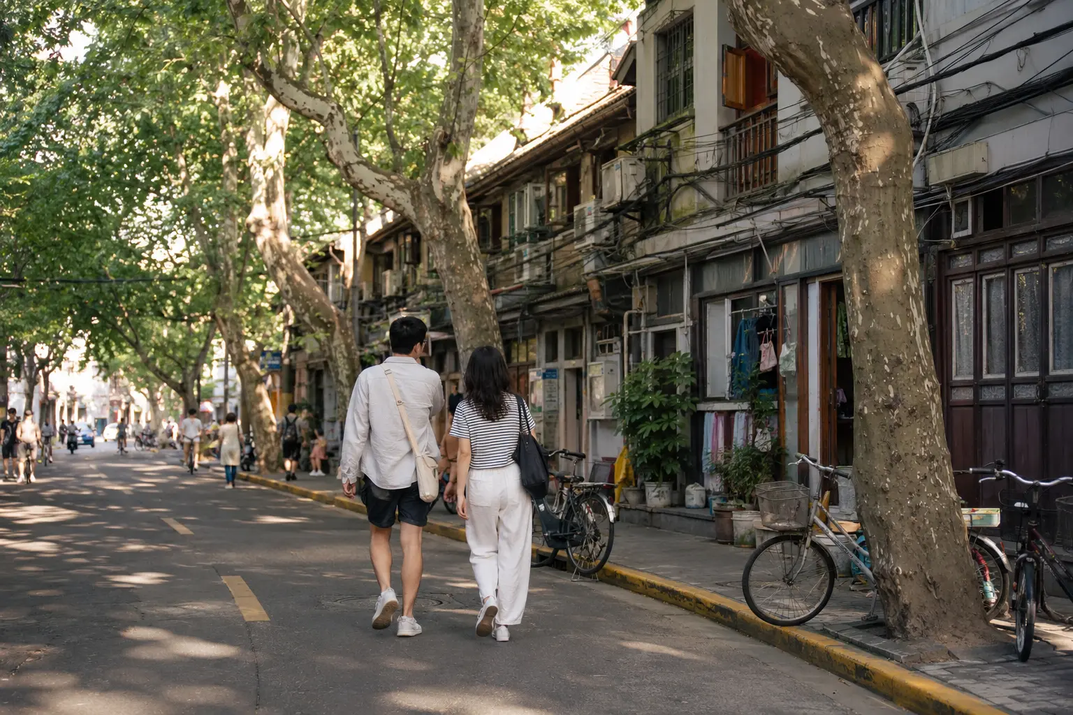 Travelers walking a leafy residential street during a former French Concession itinerary day