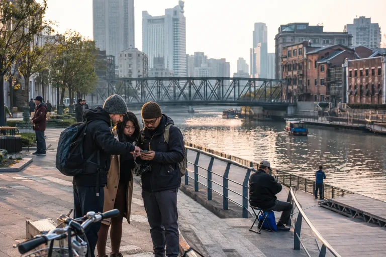 Travelers checking a walking route beside Suzhou Creek in Shanghai