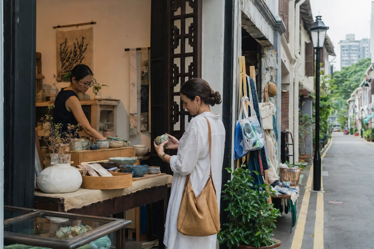 Traveler examining ceramics at an independent Singapore shop