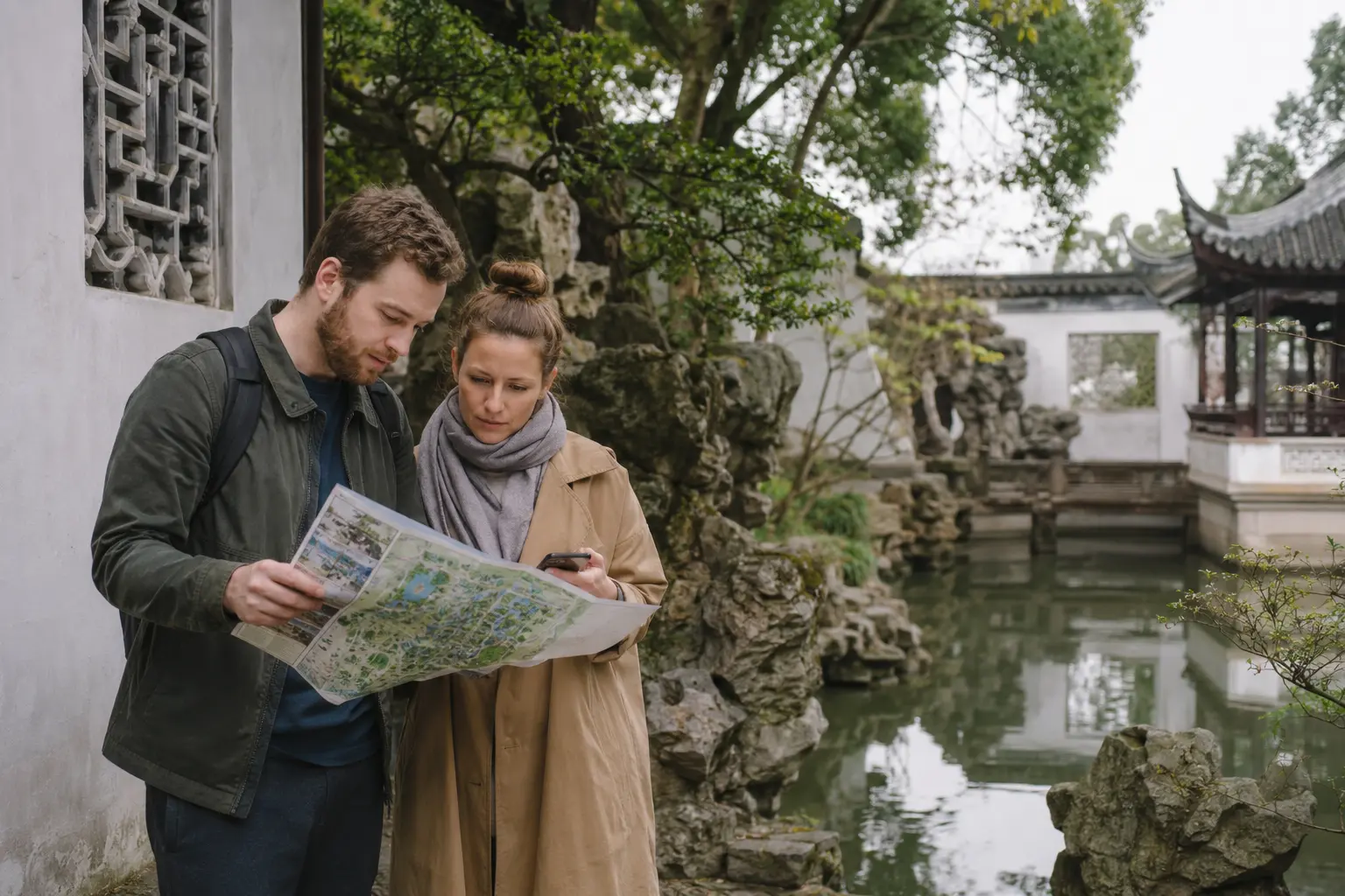 Travelers planning a route inside a classical Suzhou garden
