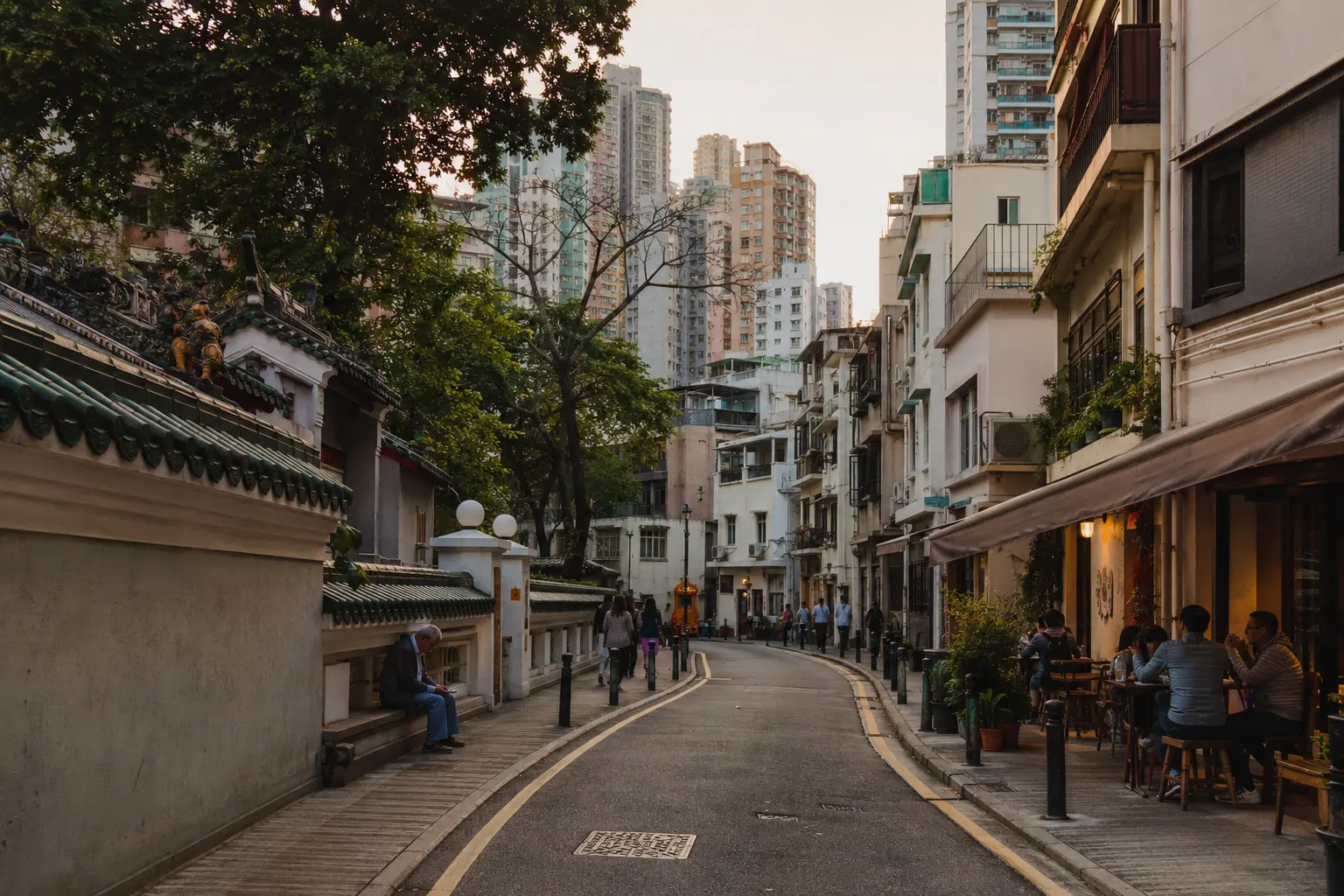 Residents walking beside a temple and small cafes in Tai Hang, Hong Kong