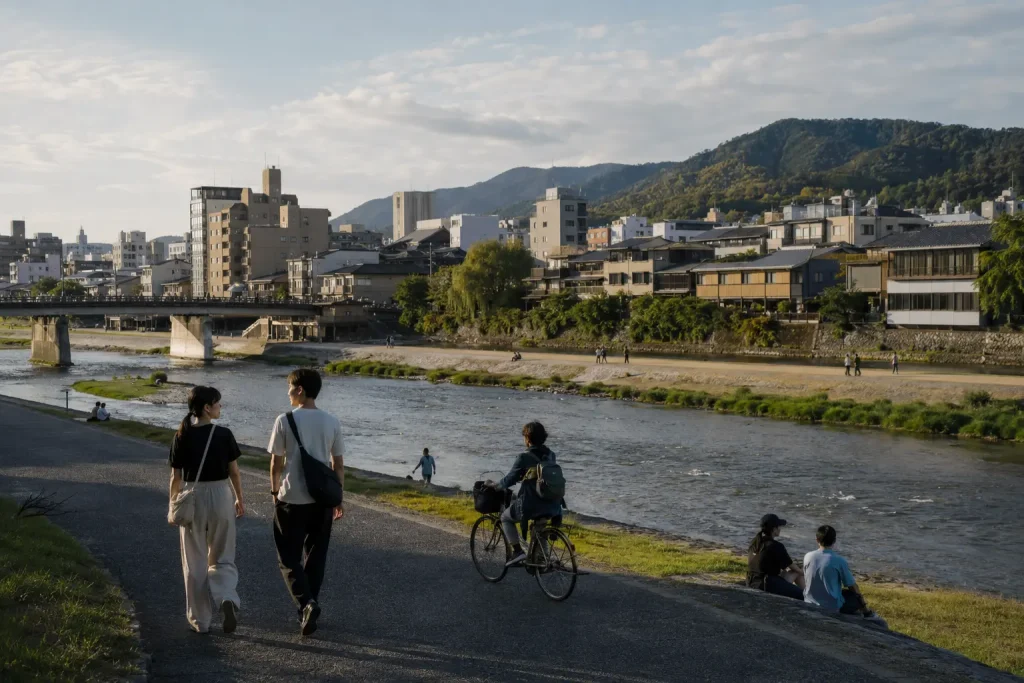 Travelers walking beside the Kamo River between central Kyoto and Higashiyama