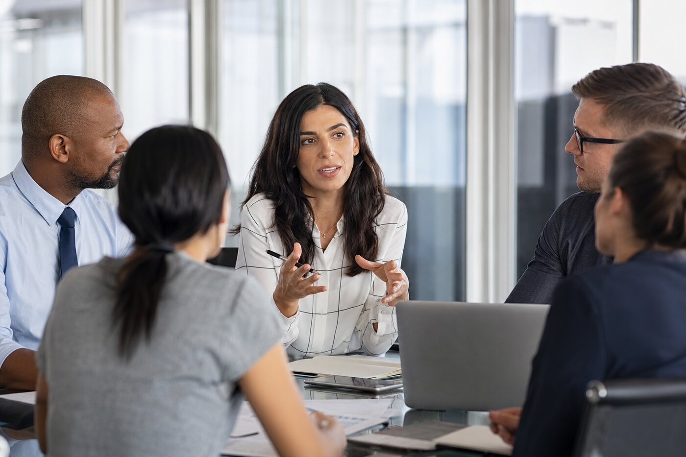 Woman speaking assertively and confidently in a work meeting