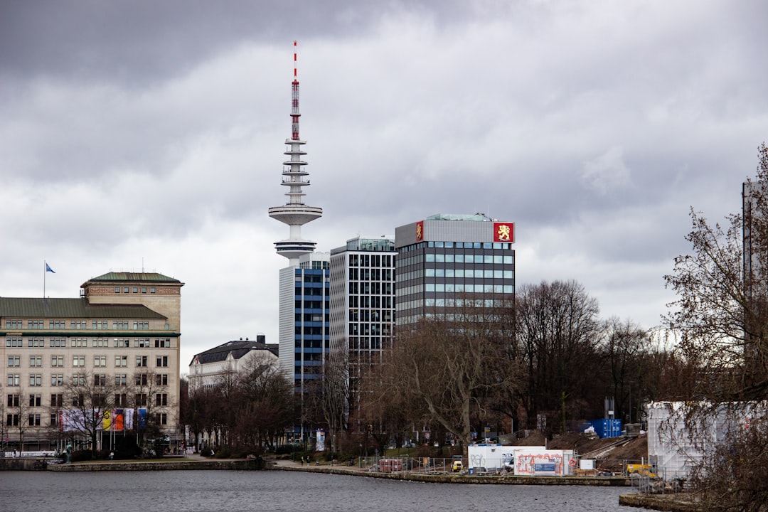 white and red tower near city buildings under white clouds during daytime — Malaysia Digital Nomad Visa: Requirements & How to Apply