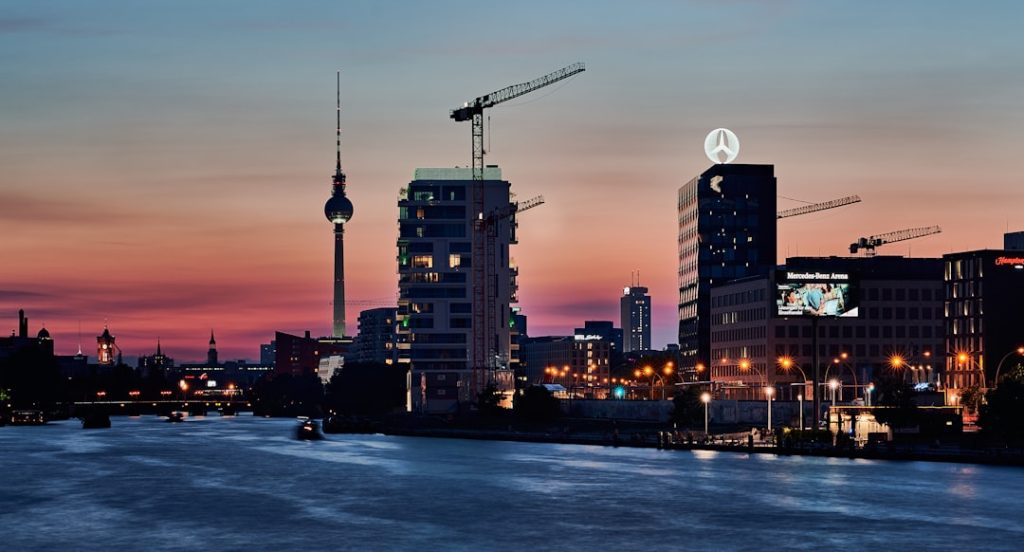 a view of a city at night from a river — uk digital nomad visa