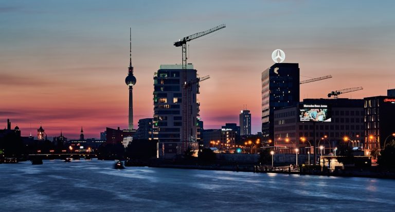 a view of a city at night from a river — uk digital nomad visa