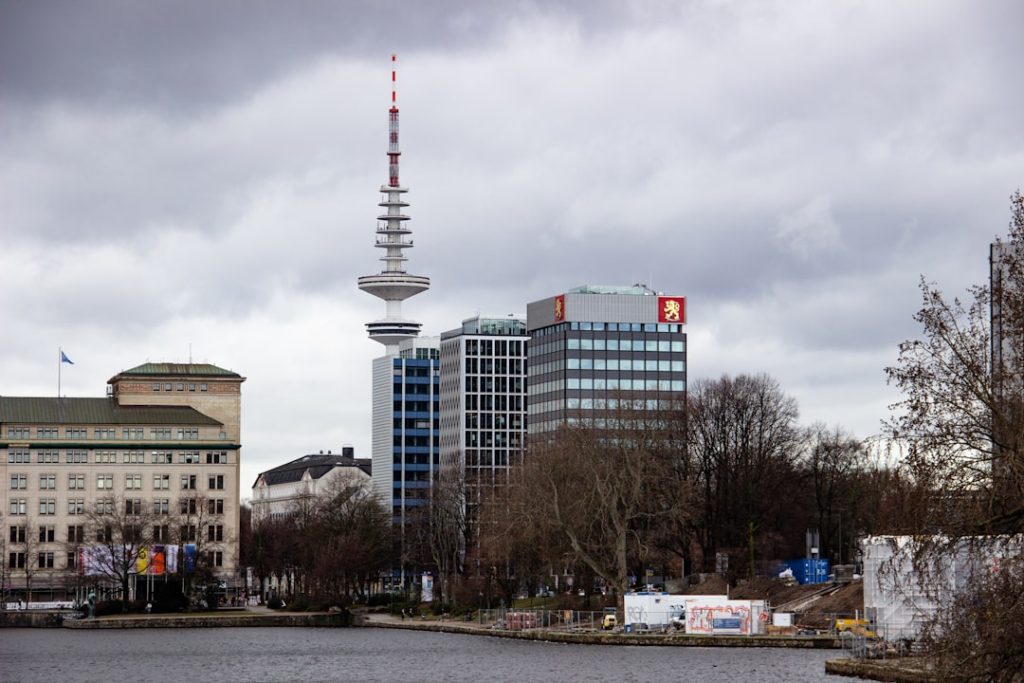 white and red tower near city buildings under white clouds during daytime — germany digital nomad visa