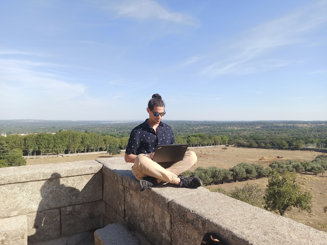 woman in black shirt sitting on gray concrete bench during daytime — How to Become a Digital Nomad: A Complete Beginner’s Guide