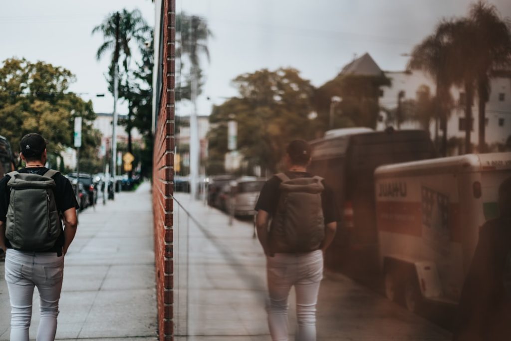 man walking with backpack photography — how to overcome the fear of failure