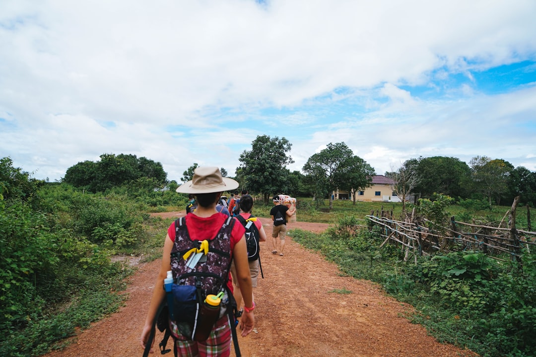 a man riding a bike down a dirt road — The Ultimate Capsule Wardrobe for Travel (Every Season, Every Trip)