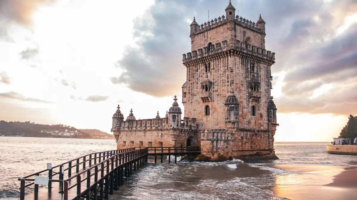 Belém Tower beside the Tagus River at sunset in Lisbon