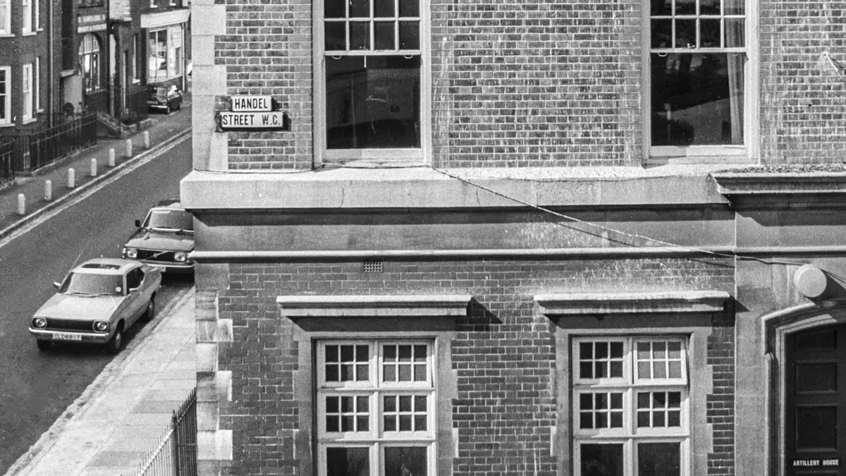 Black-and-white view of a brick corner building on Handel Street in Bloomsbury