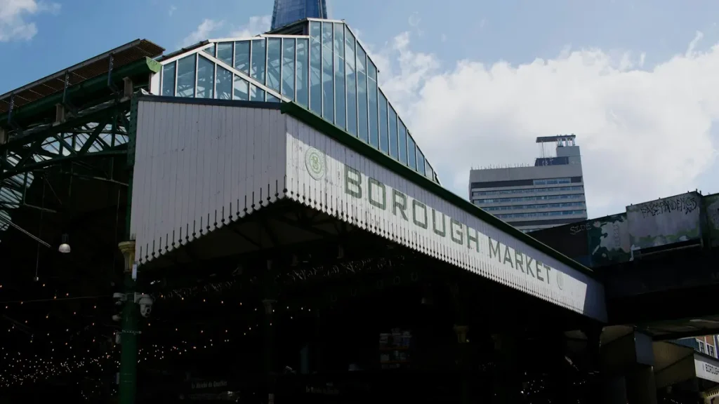 Borough Market building and food stalls beneath modern London architecture