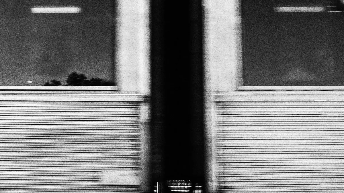 Black-and-white close-up of a train in motion on the Cascais Line in Portugal