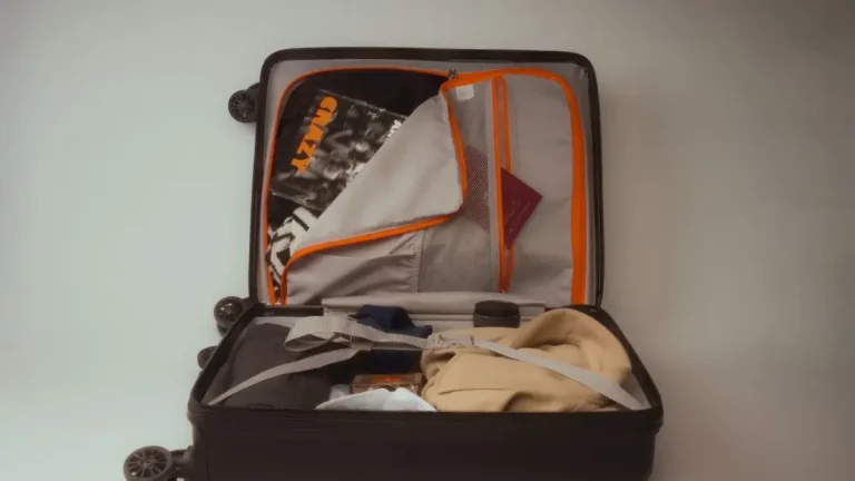 Open suitcase packed with clothing and travel essentials for a Europe trip