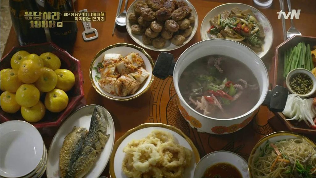 Reply 1988 family meal scene with shared dishes
