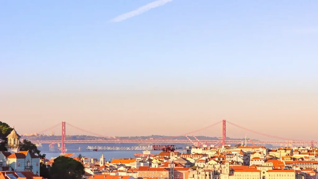 Lisbon rooftops overlooking the Tagus River and 25 de Abril Bridge