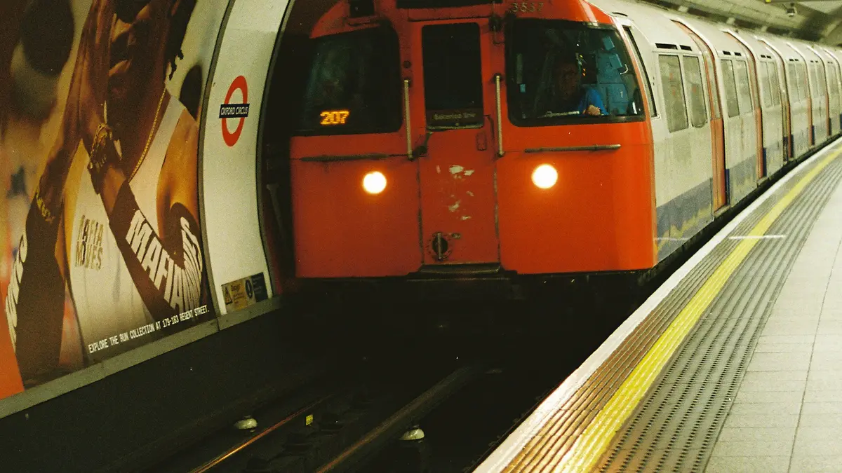 London Underground train arriving beside a station platform
