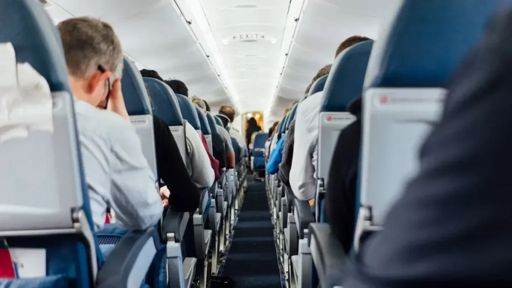 Passengers seated in an economy-class airplane cabin