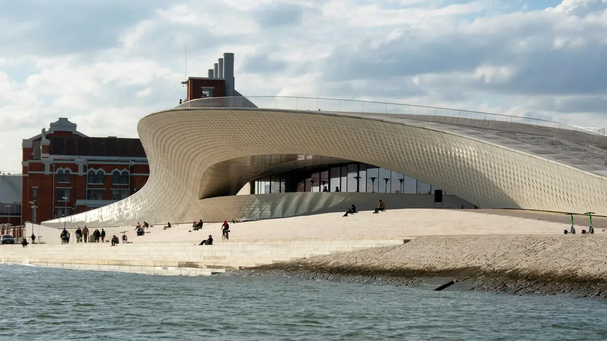 Curved white façade of MAAT beside the waterfront in Belém, Lisbon