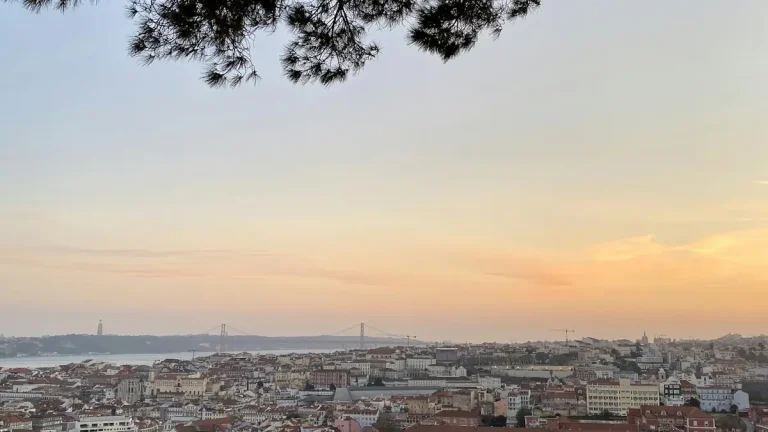 Lisbon rooftops and the 25 de Abril Bridge viewed from Miradouro de Santa Catarina