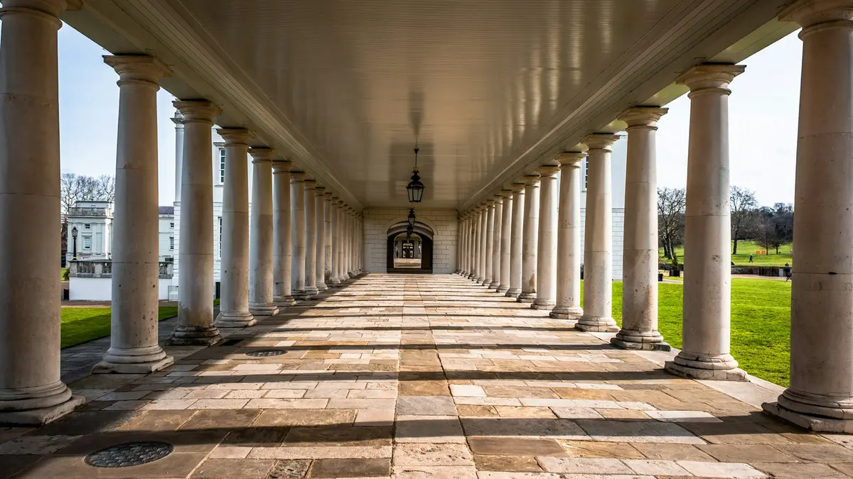 Sunlit stone colonnade at the National Maritime Museum in Greenwich