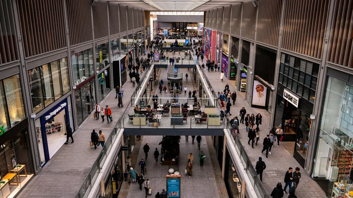 People walking through a covered shopping arcade in Oxford