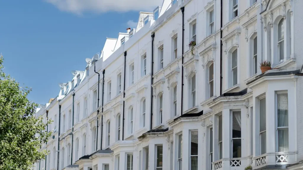 Row of white Victorian terraced houses in Paddington under a blue sky