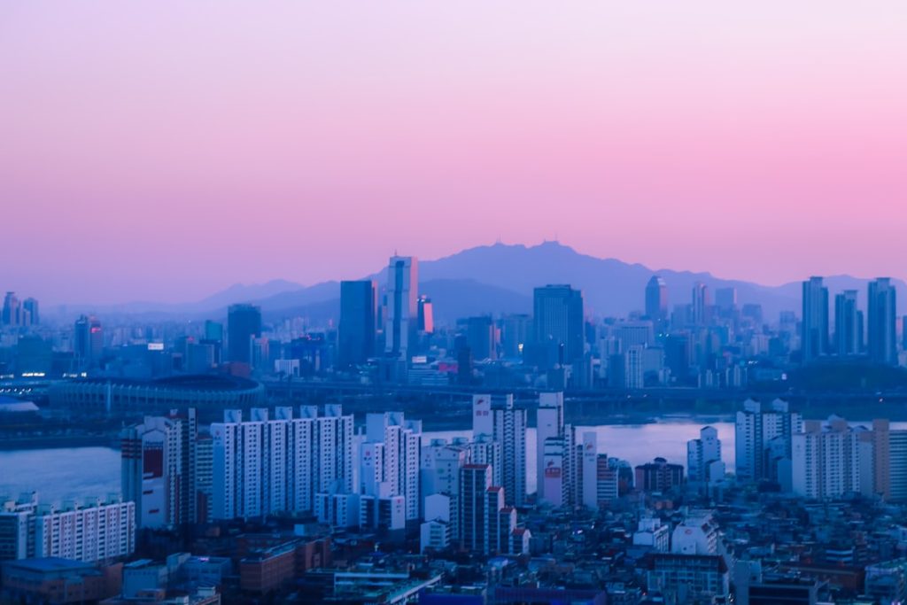Seoul skyline beneath a soft pastel sky
