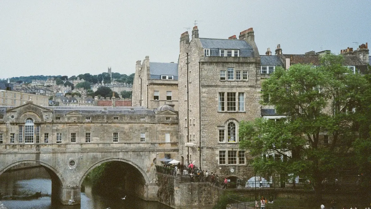 Pulteney Bridge and stone buildings beside the River Avon in Bath