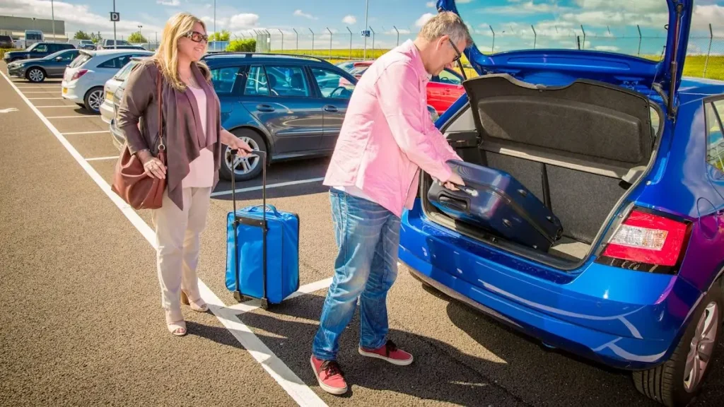 Couple loading luggage into a car for a road trip