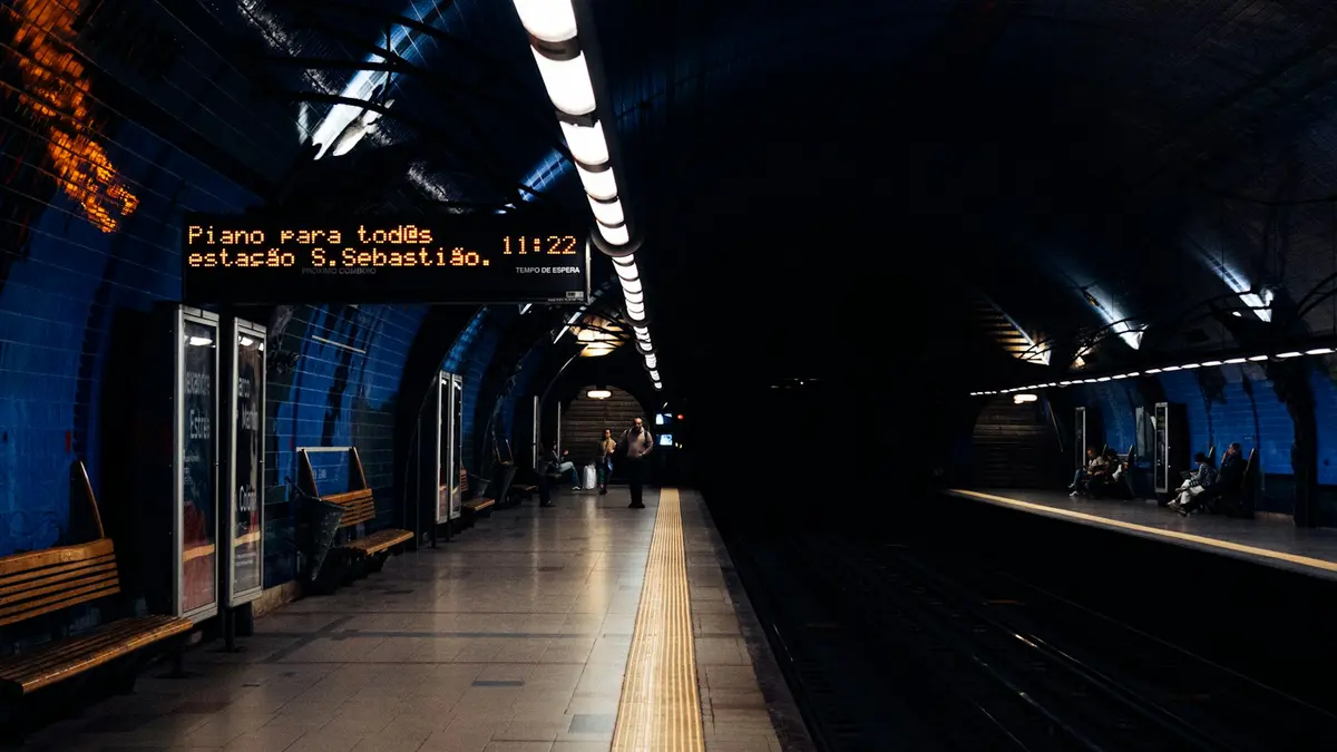 Blue-tiled platform and passenger display inside São Sebastião Metro station