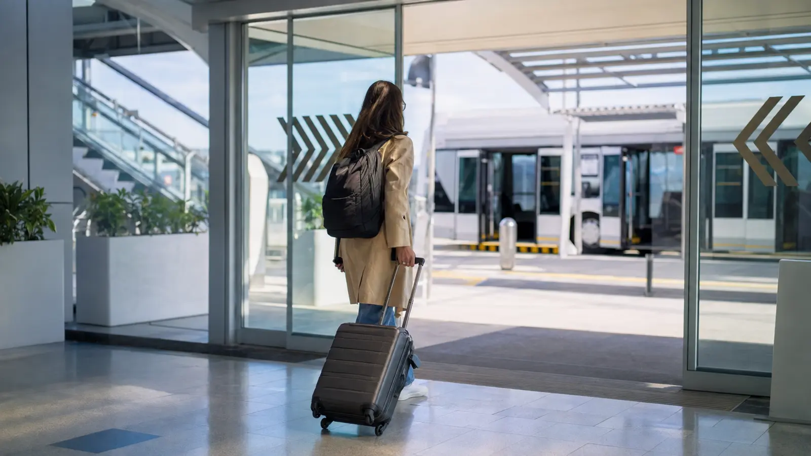 Passenger changing airport terminals with luggage during a self-transfer