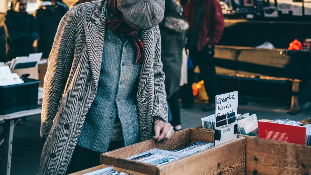 A visitor browsing boxes of secondhand books beneath Waterloo Bridge on London's South Bank