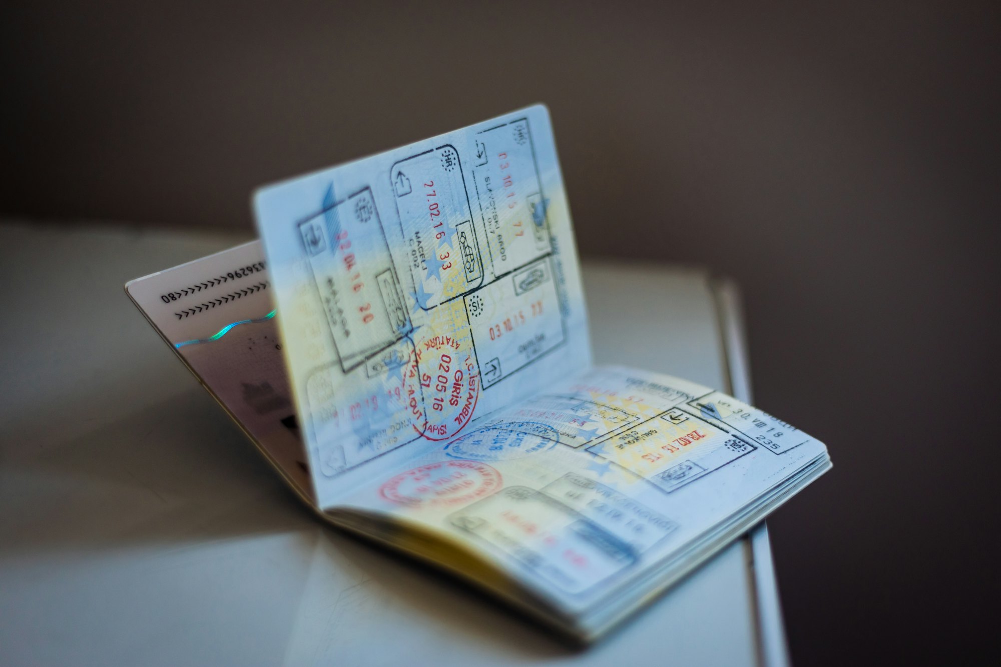 An open passport filled with entry and exit stamps from multiple countries