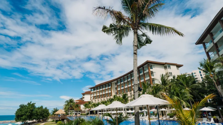 Palm trees and pool at a tropical all-inclusive resort
