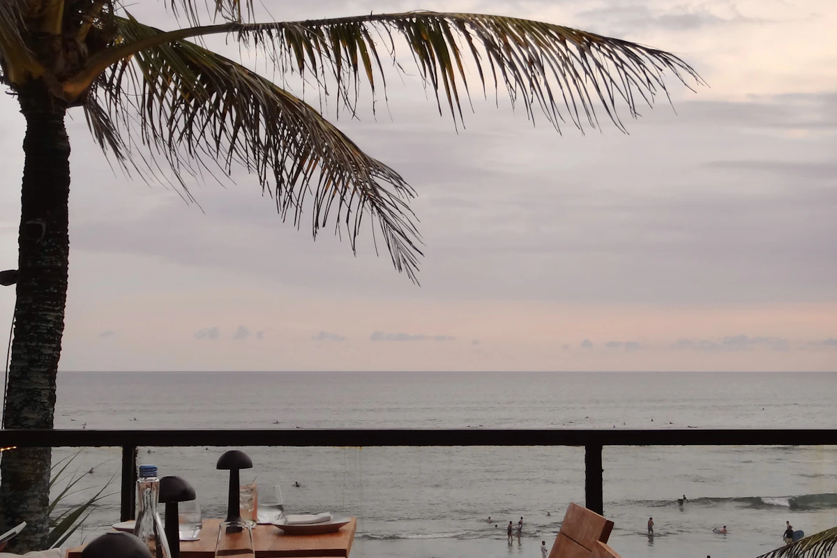 Open-air resort restaurant tables set at sunset