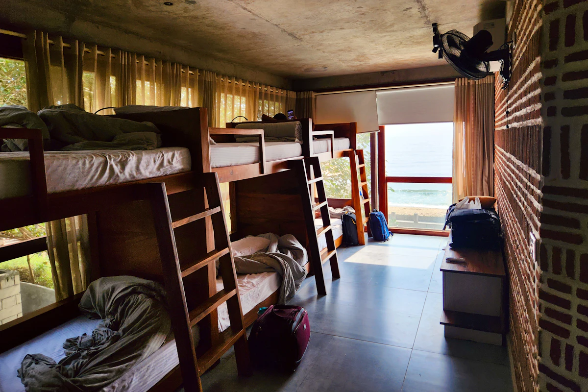 A hostel dorm room with wooden bunk beds