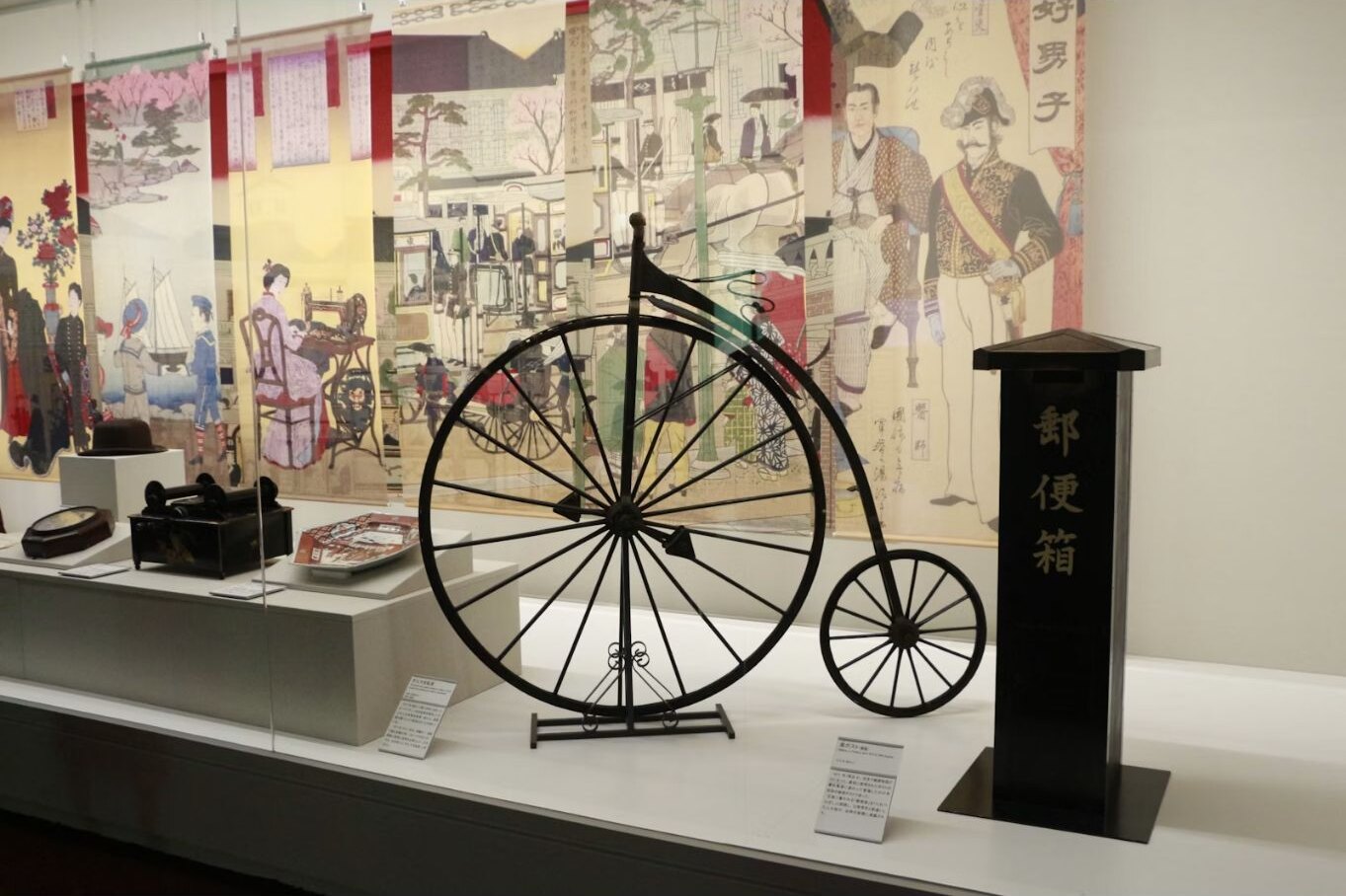 Historical Japanese objects and a penny-farthing in a museum display