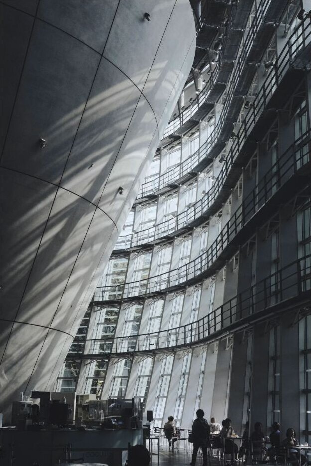 Visitors walking through a modern museum interior in Tokyo