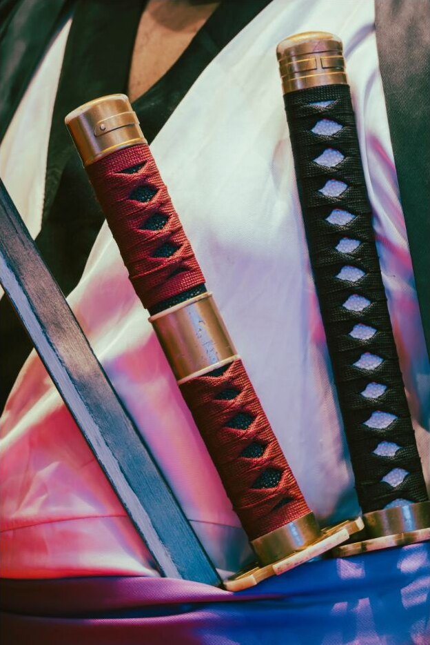 Ornate Japanese sword handles displayed on fabric